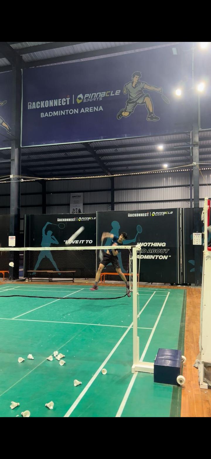 Player smashing at the net on a professional badminton court