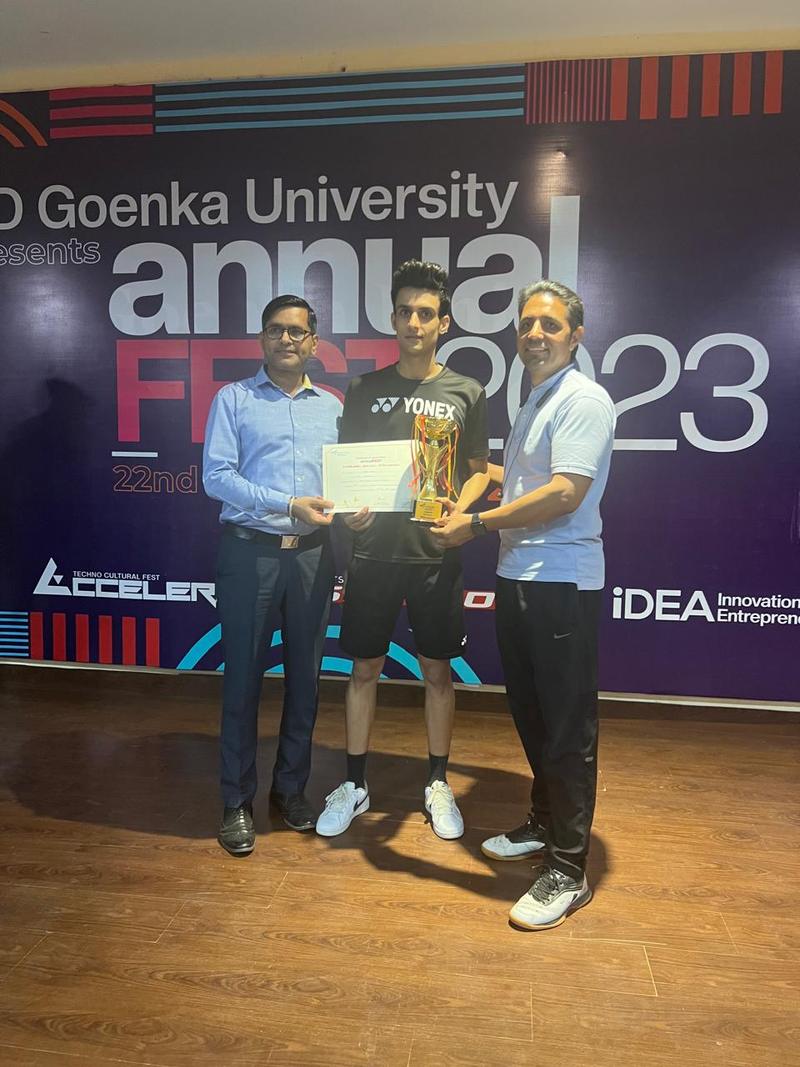 Badminton champion receiving trophy and certificate at university tournament